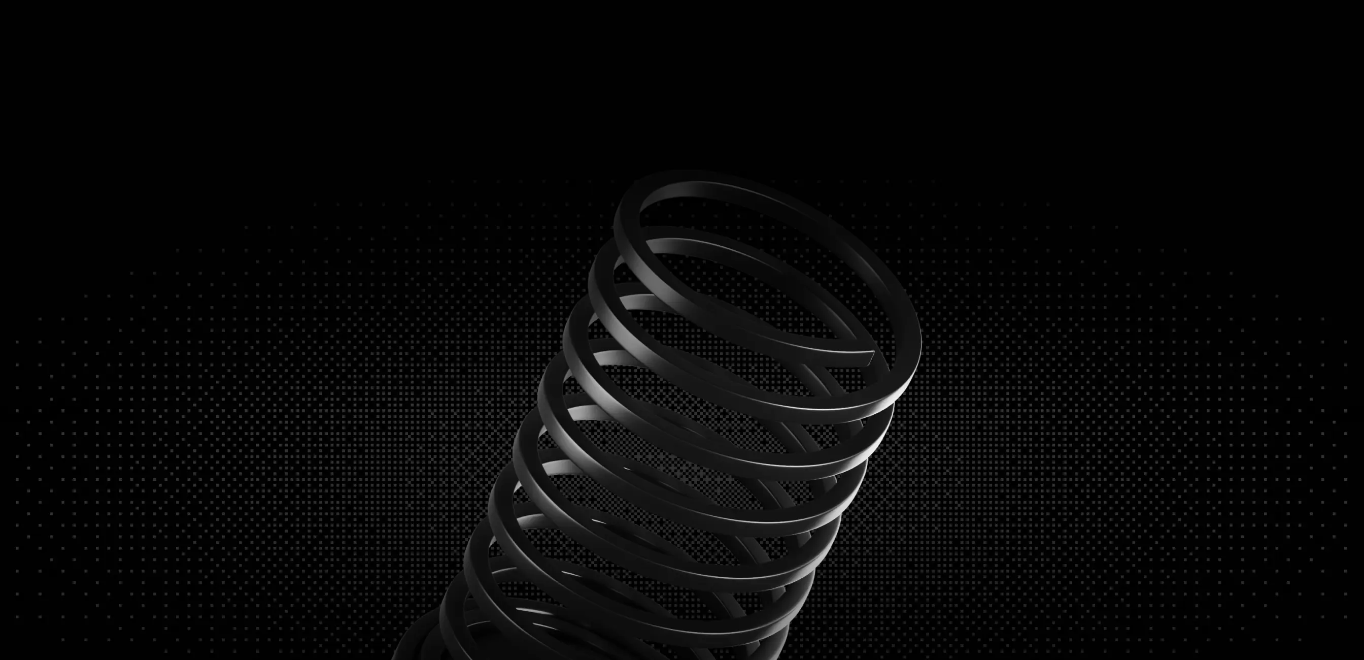 Close-up of black metallic coil spring on a dark dotted background.
