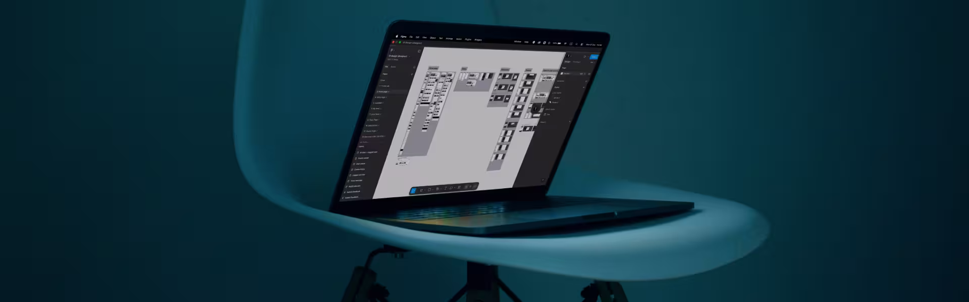 Laptop displaying a complex flowchart or diagram with multiple connected boxes, placed on a modern blue chair against a dark teal background.