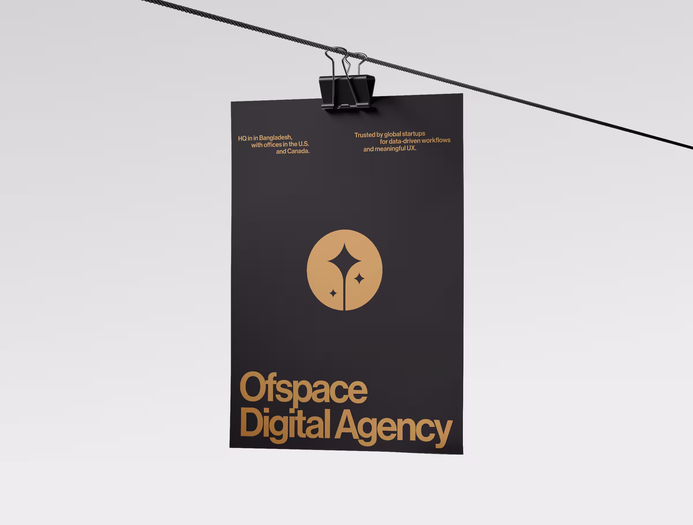 Black poster with a gold circular logo and bold ‘Ofspace Digital Agency’ branding, hanging from a clipped wire against a minimal light background