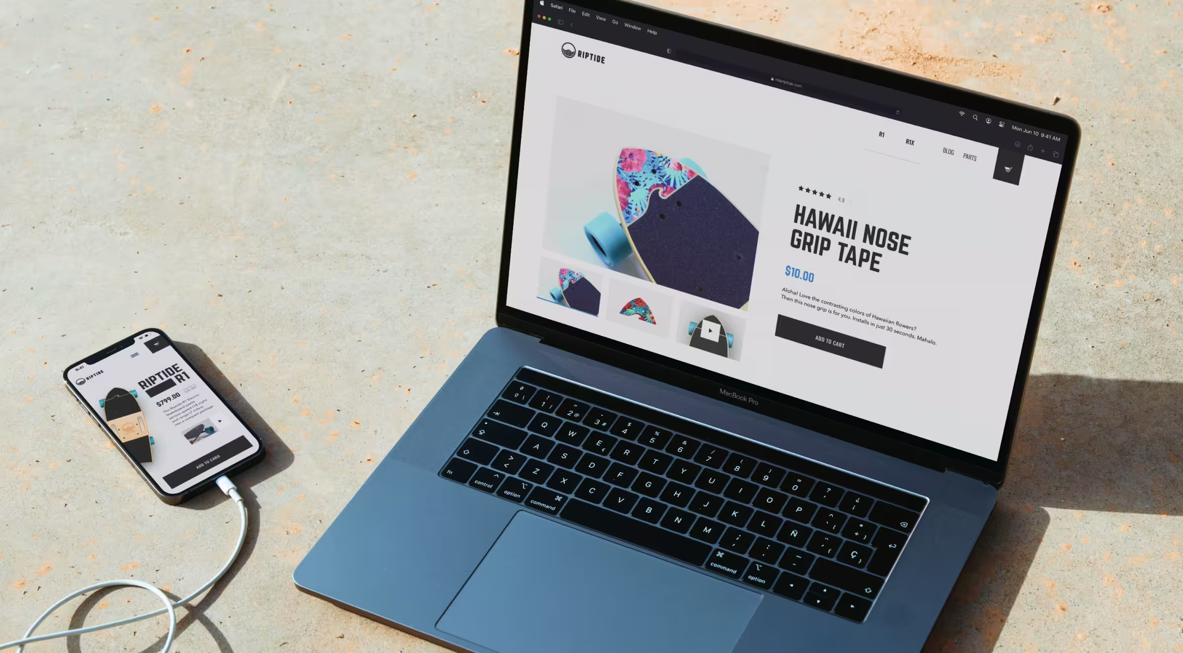 A MacBook Pro and an iPhone are placed on a concrete surface, both displaying product pages from the Riptide skateboard brand. The laptop screen shows a colorful grip tape product called "Hawaii Nose Grip Tape" priced at $10, while the phone shows a different skateboard product. The website interface is clean and modern, optimized for both desktop and mobile viewing.