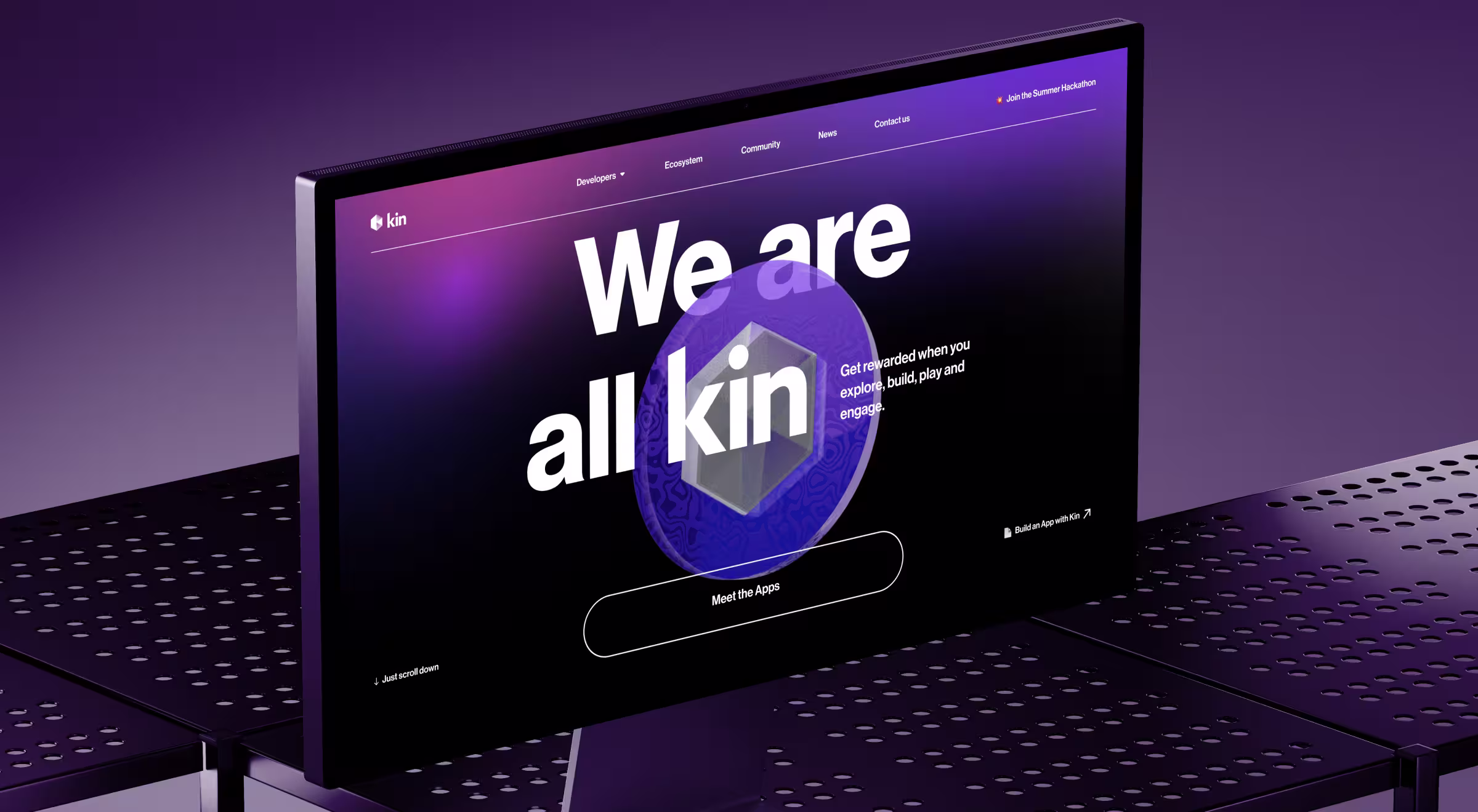 Desktop monitor showcasing the Kin ecosystem website against a purple gradient background. Large typography, a three-dimensional token graphic, and a prominent call-to-action create a futuristic digital product experience focused on community engagement and blockchain technology.