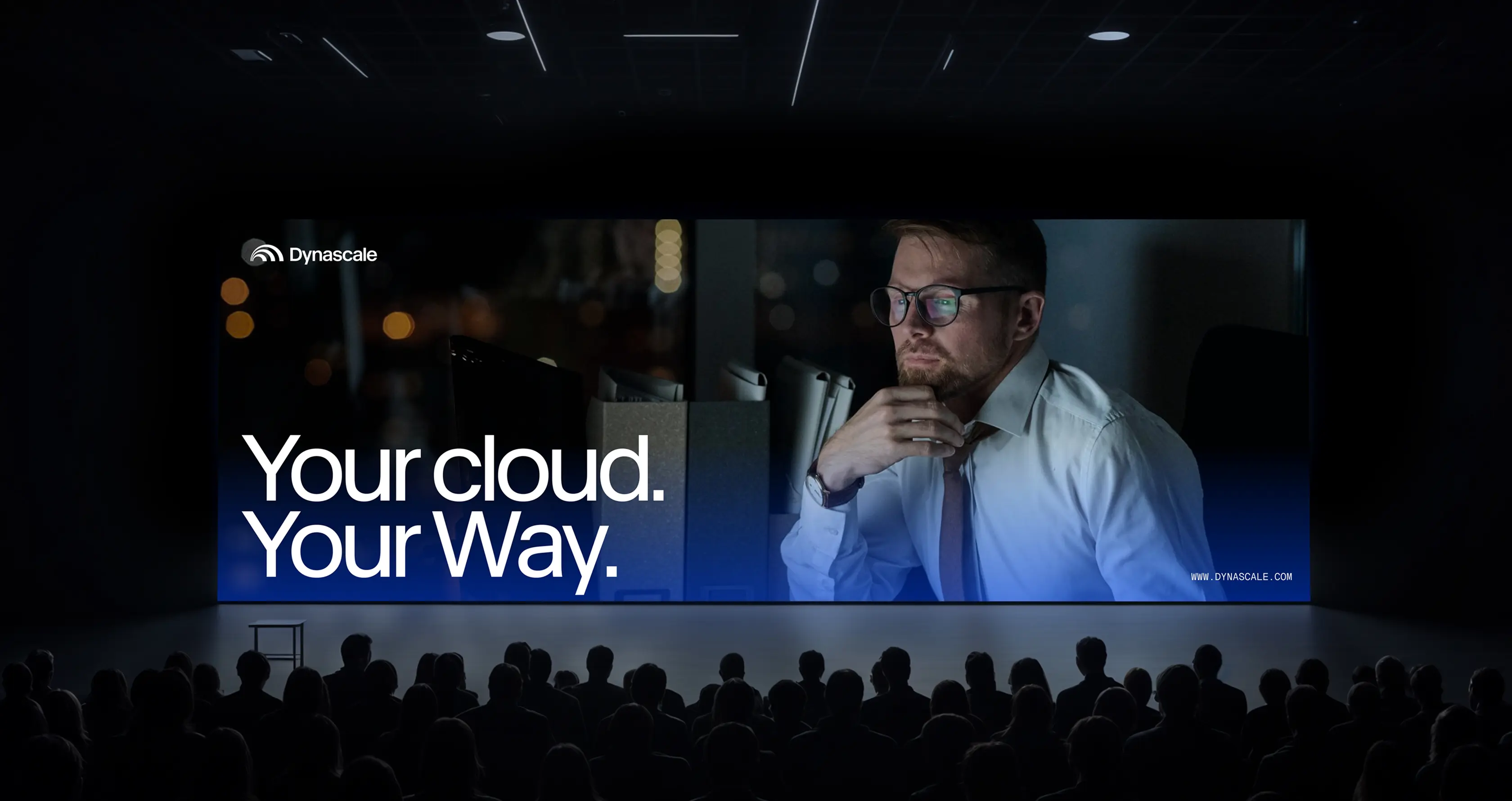 Large screen reading "Your cloud. Your Way." with Dynascale branding, shown before an audience