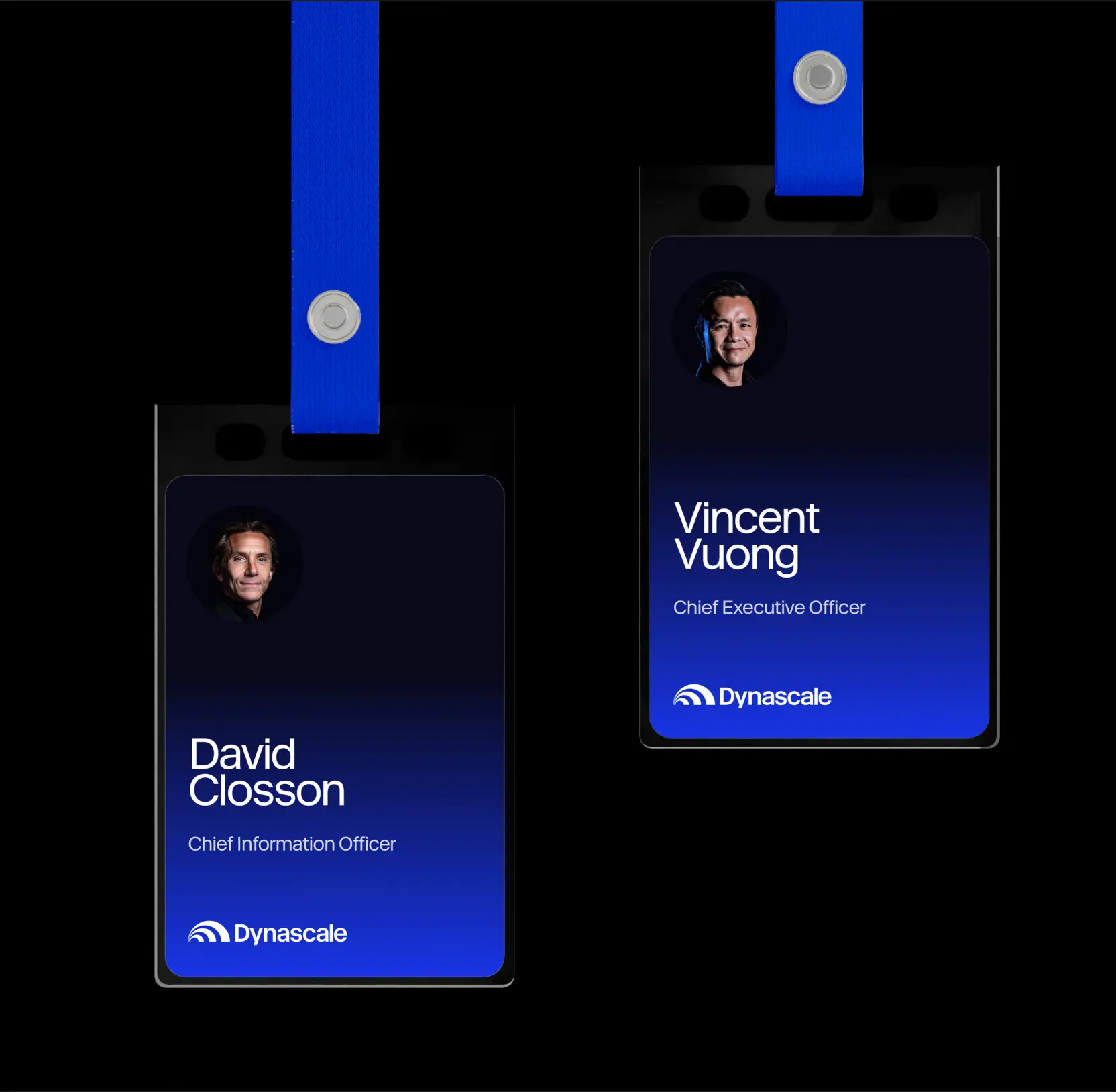Two Dynascale employee ID badges on blue lanyards, with photo, name, and job title