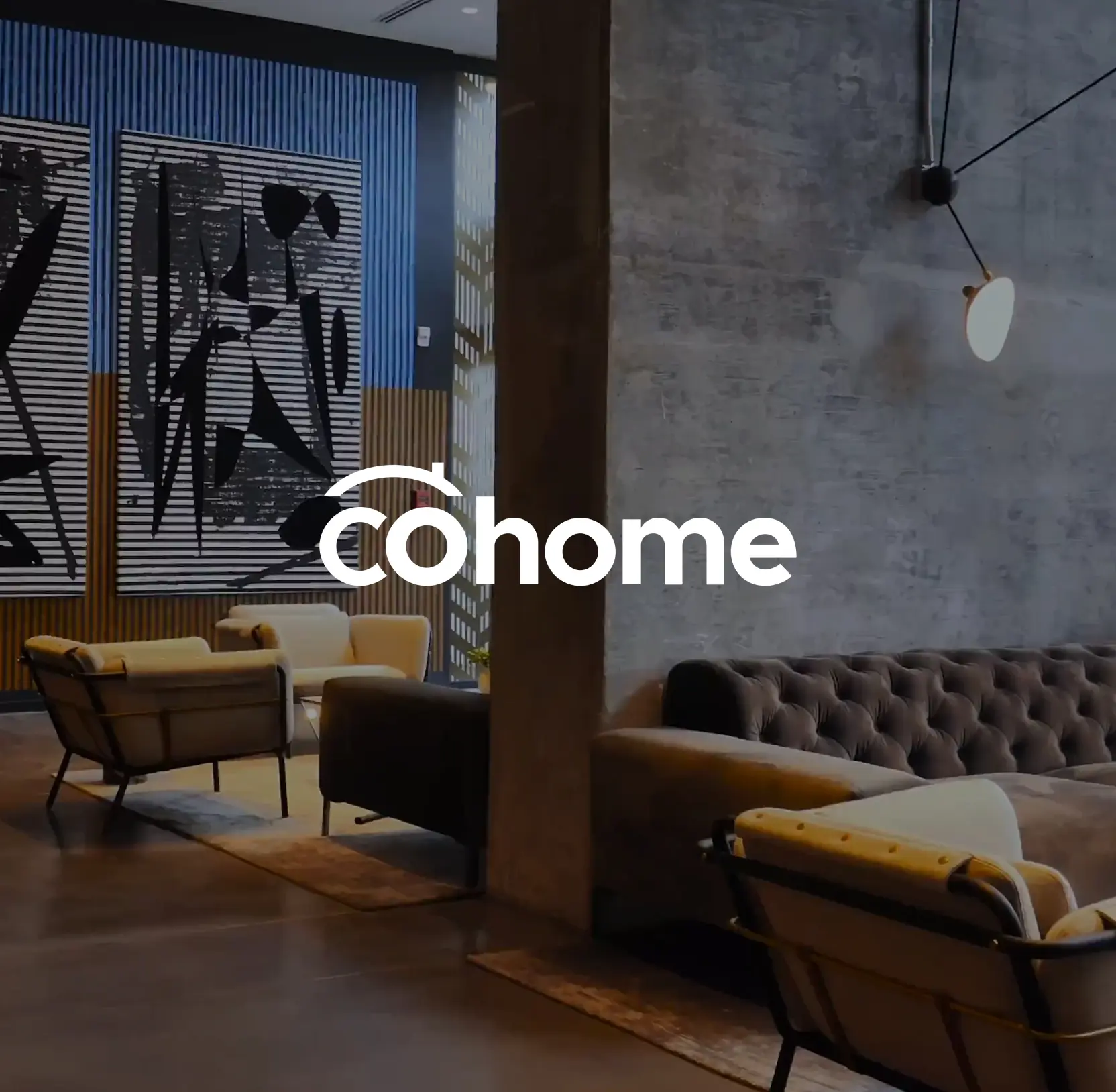 Cohome logo over a modern living space with armchairs and a leather sofa