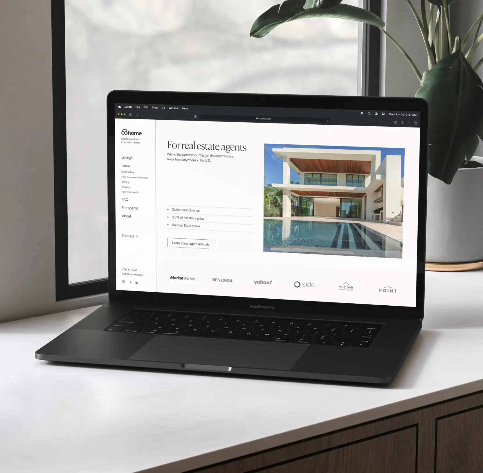 Cohome property listing on a laptop, showing a house photo and detail tabs