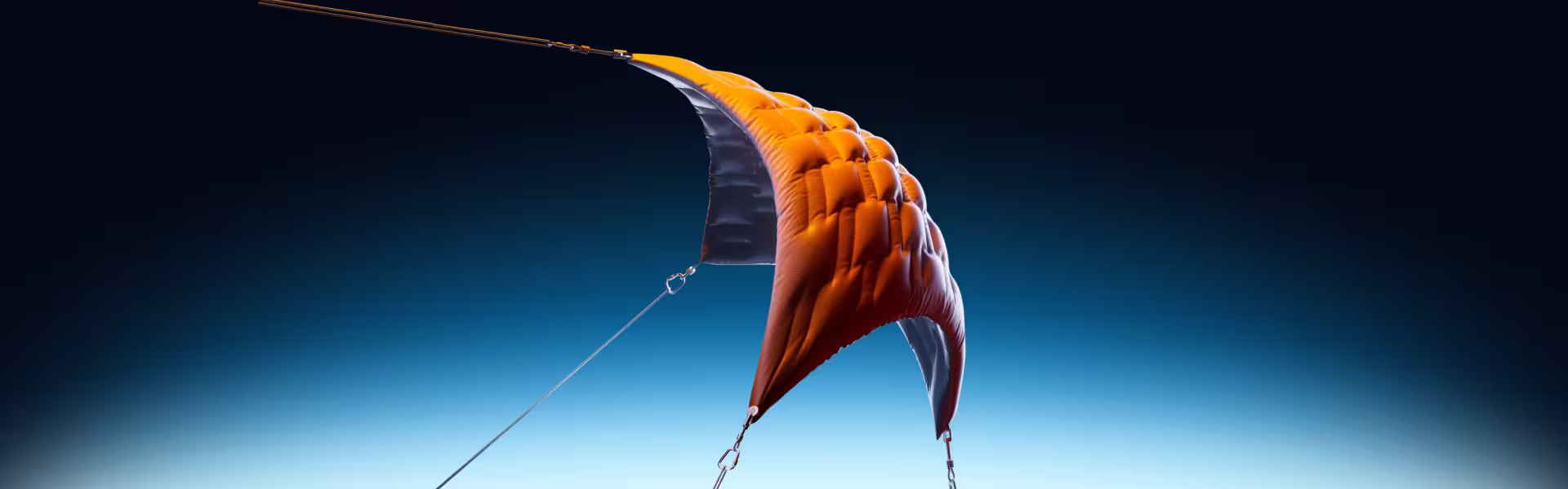 3D render of an orange paraglider canopy with suspension lines against a blue-to-black gradient sky