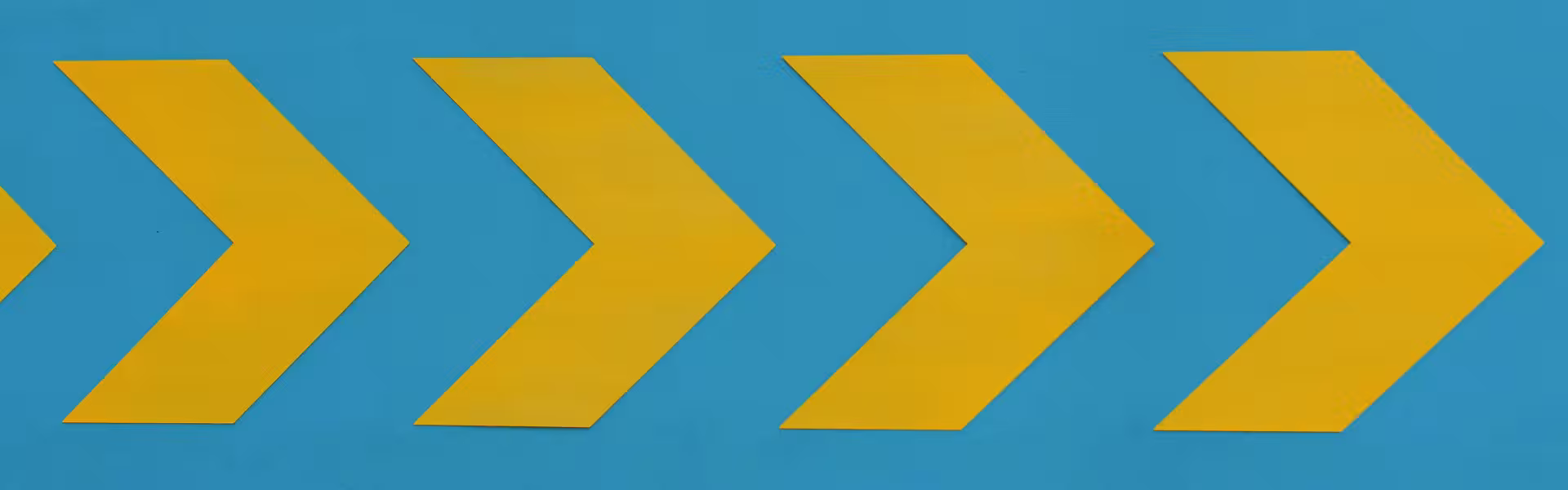 Yellow arrow shapes pointing right on a bright blue background