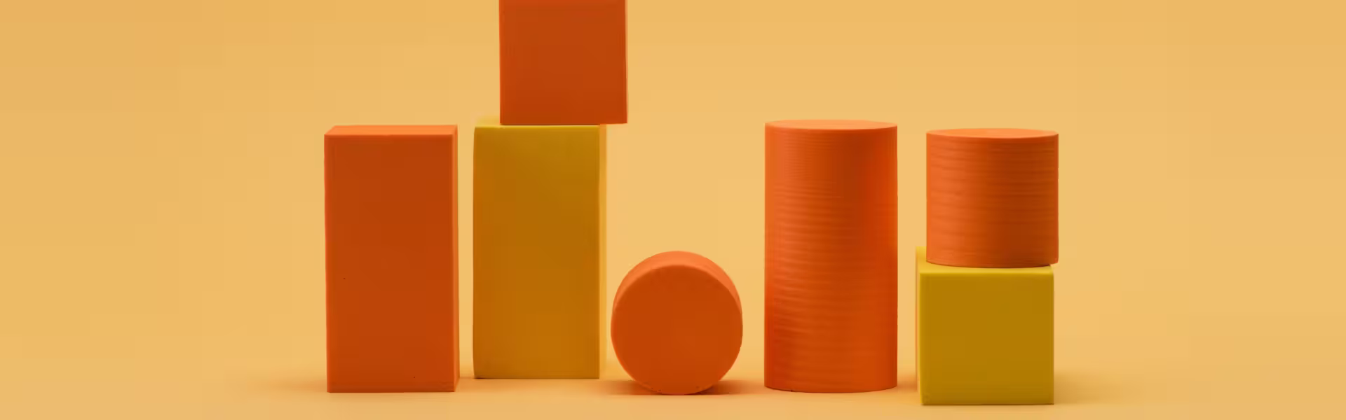 Abstract 3D composition of orange and yellow geometric blocks symbolizing structure and balance in web design