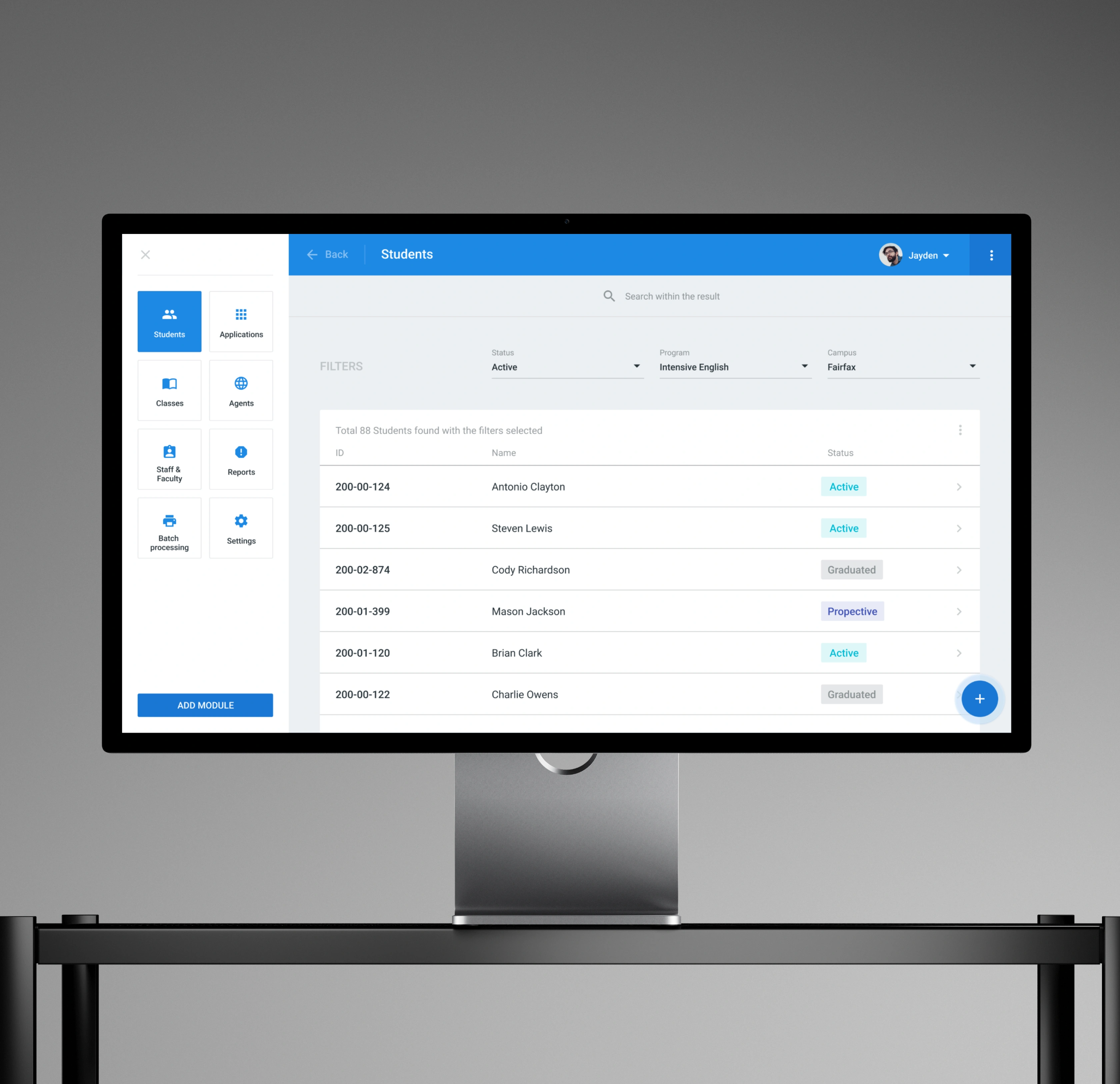 Campus AXESS students page on a desktop monitor, filtering a roster by status, program, and campus with a searchable list of student IDs, names, and enrollment statuses.