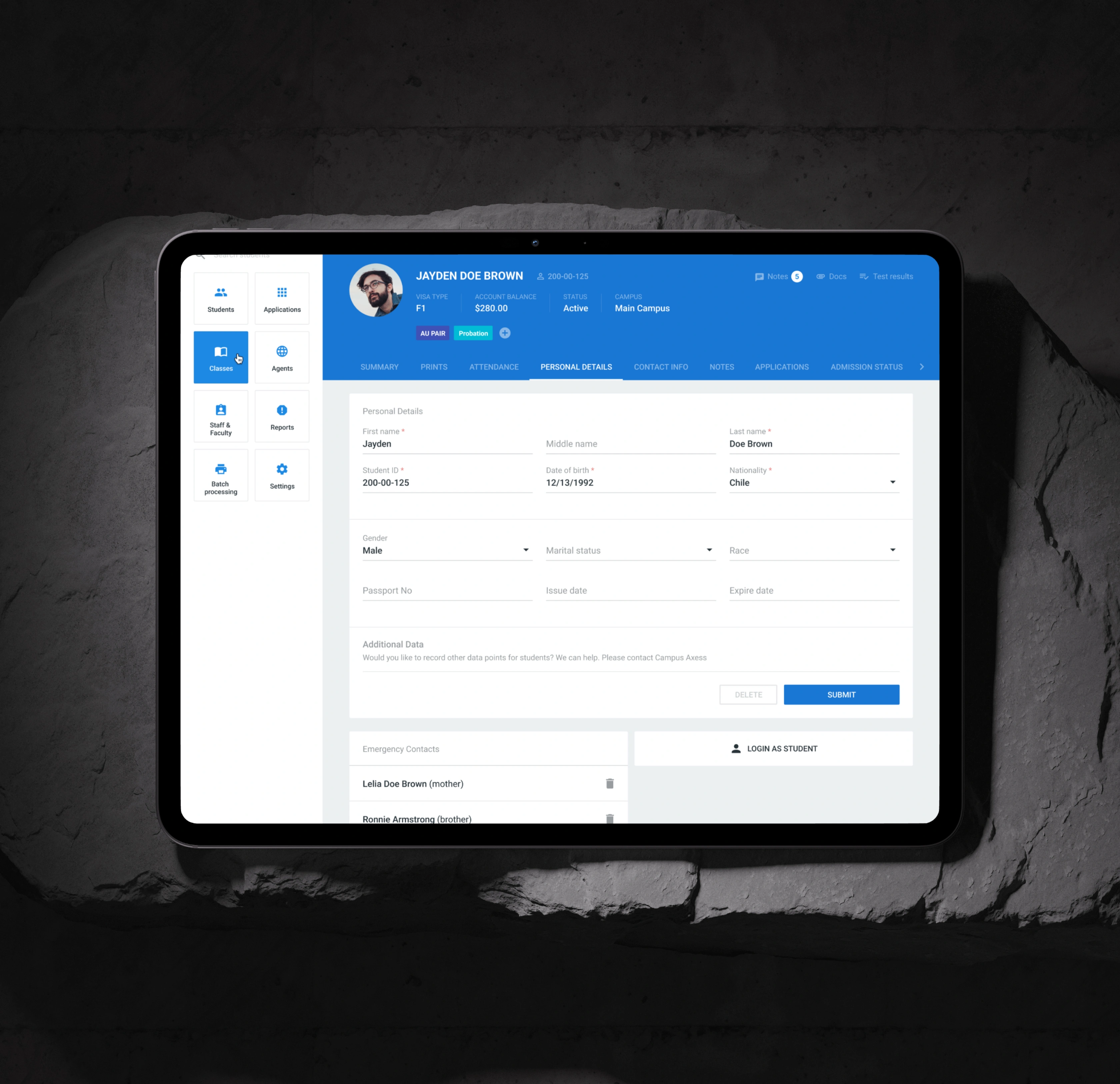 Campus AXESS personal details record open on a tablet, with editable fields for identity, nationality, and passport data, alongside emergency contacts and a login-as-student action.